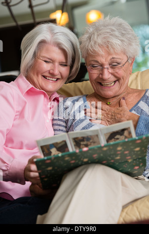 Young women looking at photo album Banque D'Images