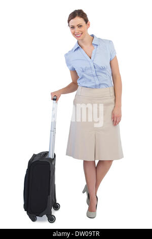 Elegant businesswoman posing with suitcase Banque D'Images