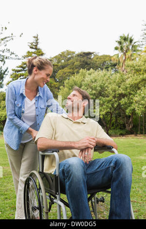 Happy man in wheelchair talking with partner Banque D'Images