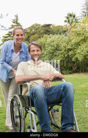 Happy man in wheelchair with partner Banque D'Images