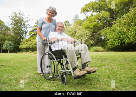 Happy man in wheelchair with partner Banque D'Images