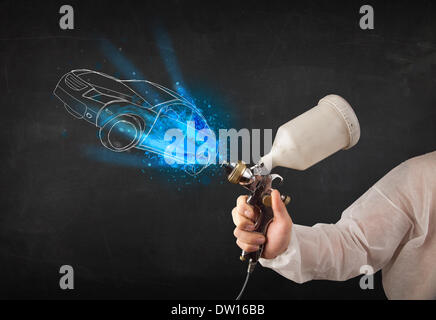 Aérographe peinture travailleur avec des lignes à la main Banque D'Images