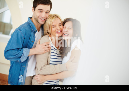 Portrait de famille heureuse de trois à la maison