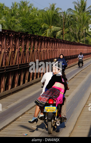 Les Laotiens équitation dans toute la moto moto/vélo pont sur la rivière Nam Kahn à Luang Prabang, Laos. Banque D'Images