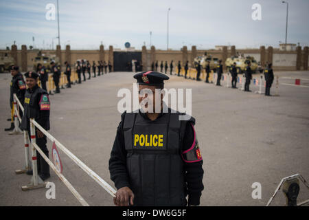 Le Caire, Égypte. 1er mars 2014. La police anti-émeute garde derrière des barbelés à l'extérieur de l'École de police où un procès de l'ancien président déchu Mohamed Morsi plus de chefs d'incitation à tuer des manifestants, l'ouverture est prévue au Caire, capitale de l'Égypte, le 1 mars 2014. Morsi et 14 autres prévenus sont accusés d'incitation à la violence et l'ordre de tuer des manifestants devant le palais présidentiel en décembre 2012. Source : Xinhua/Chaoyue Pan/Alamy Live News Banque D'Images