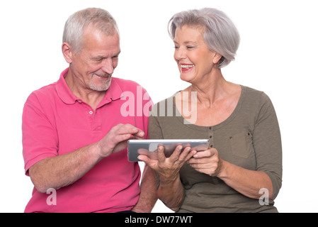 Senior couple with tablet computer in front of white background Banque D'Images