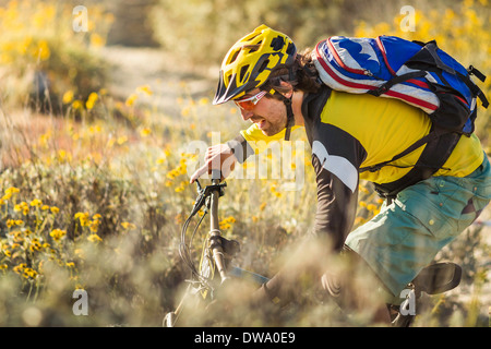 Young man mountain biking, Fontana, California, USA