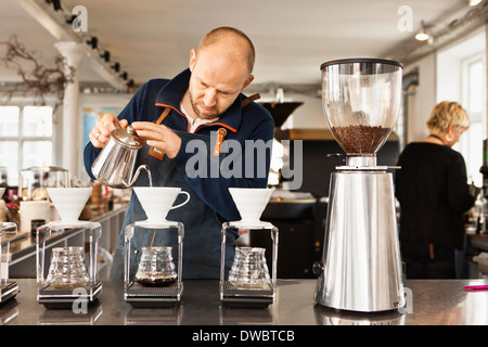 Barista de verser de l'eau bouillante dans les filtres à café Banque D'Images