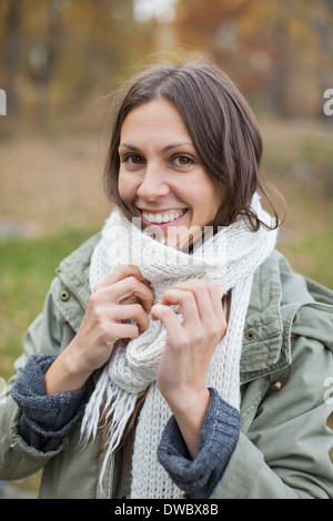 Portrait of happy woman wearing scarf outdoors Banque D'Images