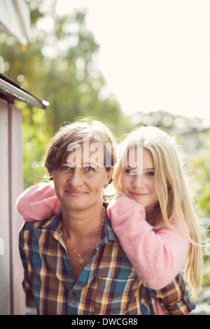 Portrait of smiling mother and daughter at yard Banque D'Images