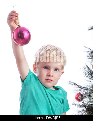 Bambin montrant un Noël Décoration violet avant qu'il le met sur l'arbre de Noël Banque D'Images