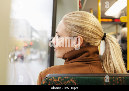 Vue arrière de la femme à la fenêtre de l'autobus par Banque D'Images