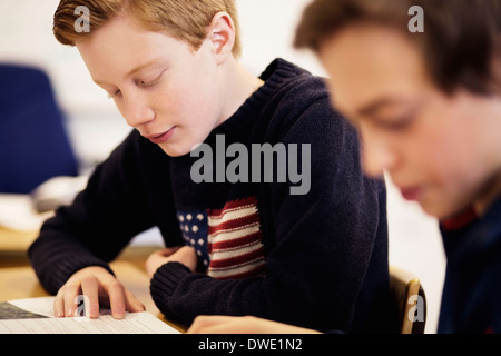 High school boys studying together in classroom Banque D'Images