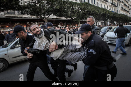 Alger, Algérie. 6Th Mar, 2014. La police à l'arrestation d'un manifestant au cours d'une manifestation contre le président algérien Abdelaziz Bouteflika a décidé de se présenter pour un quatrième mandat, à Alger, le 6 mars, 2014 Bouteflika, qui a aidé à mettre fin à l'Algérie des années 1990, la guerre civile dévastatrice, mais dont la récente règle a été tourmentée par les scandales de corruption, a déclaré à la télévision algérienne le 3 mars qu'il avait inscrit comme candidat à l'élection. Credit : Kamel Salah/NurPhoto ZUMAPRESS.com/Alamy/Live News Banque D'Images