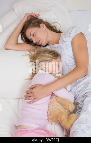 Mère et fille dormir paisiblement avec doudou dans le lit Banque D'Images