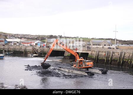 West Bay, Dorset, UK . 07Th Mar, 2014. Des travaux de dragage dans l'embouchure de la rivière Brit à West Bay, Dorset, où les inondations et les hautes marées ont provoqué de graves dégâts. Wwest Bay est aussi l'endroit où la série TV 'Broadchurch" a été filmé. Les inondations, les inondations. Crédit : Tony Charnock/Alamy Live News Banque D'Images