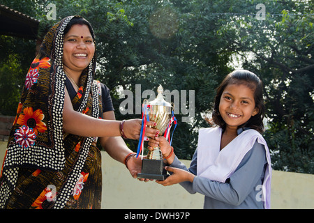 Indian woman giving trophée à kids Banque D'Images