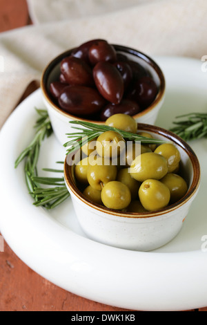 Olives vertes et noires marinées (Kalamata) dans un bol en céramique Banque D'Images