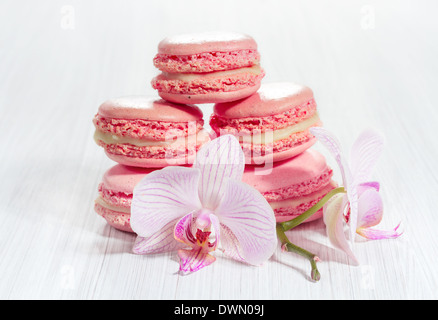 Macarons français rose sur un fond de bois. Banque D'Images