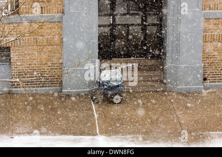 A New York City's Mailman panier à roues sur le trottoir pendant une tempête de neige Banque D'Images