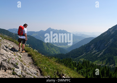 Randonneur marchant sur les sentier menant à Taubenstein Mountain Lake, région de Spitzingsee, Haute-Bavière, Bavière, Allemagne Banque D'Images