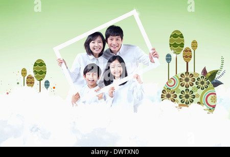 Une famille détenant une image dans les nuages Banque D'Images