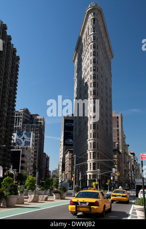 Les taxis jaunes conduisant vers le Flatiron Building à New York, USA Banque D'Images