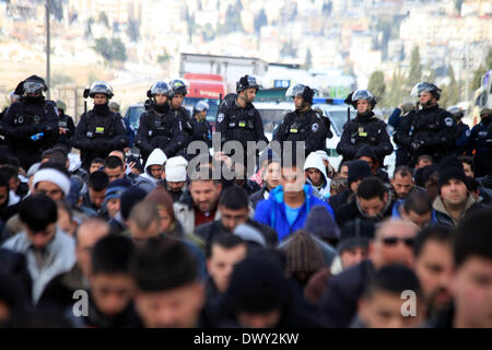 Jérusalem, Jérusalem, territoire palestinien. 14Th Mar, 2014. Prier les musulmans palestiniens à l'extérieur de la vieille ville de Jérusalem comme la police israélienne les bloquer de prier dans la mosquée Al-Aqsa de la ville, dans le quartier de Ras Al-Amoud à Jérusalem le 14 mars 2014. Israël restreint l'entrée pour la prière du vendredi à la mosquée al-Aqsa pour éviter d'éventuels affrontements Crédit : Saeed Qaq/APA Images/ZUMAPRESS.com/Alamy Live News Banque D'Images