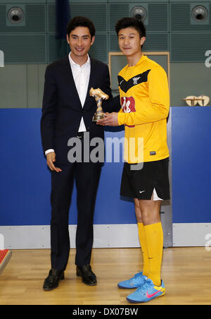 Cambridge, UK. Mar 15, 2014. Alex Hua Tian (L), un sportif Équestre Olympique pour la Chine, la remise des prix du trophée MVP à Kwok Yin Tang Marco de l'Université de Sheffield La société de Hong Kong (SHKS) Équipe au cours de la cérémonie, pour la France, cinq Chinois-A-side football intérieur University Cup 2014 à l'Université de Cambridge Sports Centre à Cambridge, en Grande-Bretagne, le 15 mars 2014. SHKS Team a demandé le titre en battant Team Chinese Students and Scholars Association à Cambridge (CSSA) avec 4-1 en finale. Credit : Wang Lili/Xinhua/Alamy Live News Banque D'Images