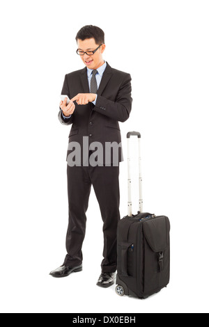 Young businessman using a cell phone with briefcase isolated on white Banque D'Images