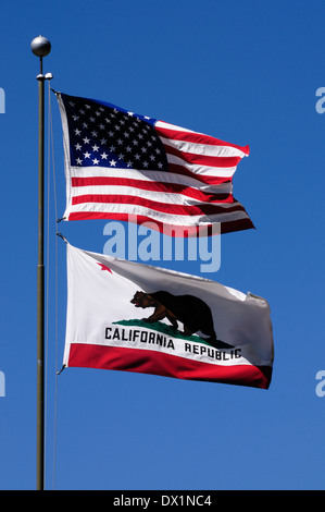 Drapeaux de la Californie et des États-Unis d'Amérique en soufflant de mât à l'avant d'un ciel bleu, California, USA Banque D'Images