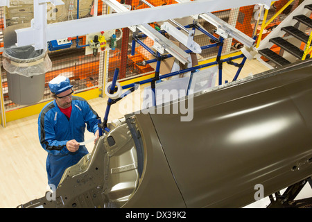 Un travailleur dans le soubassement de l'étanchéité et revêtement de pont à gare de l'atelier de peinture de Chrysler's Sterling Heights Usine de montage. Banque D'Images