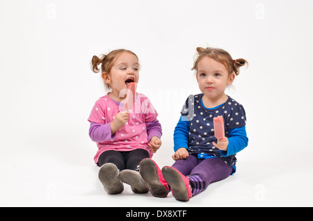 Twin girls eating ice cream et profiter de la compagnie de l'autre Banque D'Images