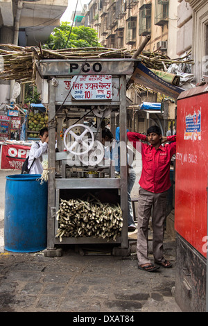 Étal de vente de jus de canne à sucre à Mumbai, Inde Banque D'Images