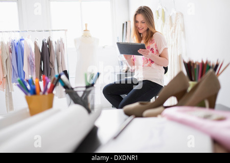 Portrait of female costume designer using digital tablet in studio Banque D'Images