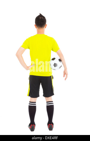 Joueur de soccer soccer holding a côté de taille en studio Banque D'Images