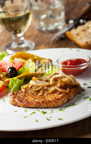 Steak de porc grillé avec des oignons Banque D'Images