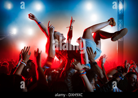 Man crowd surfing at music festival Banque D'Images