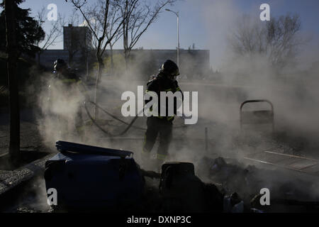 Madrid, Espagne. Mar 27, 2014. Les pompiers éteindre le feu d'une barricade au cours de la deuxième journée de grèves des étudiants pour protester contre le gouvernement de réforme de l'éducation et la réduction des subventions et la dotation en personnel, de l'Université Complutense à Madrid, Espagne, le Jeudi, Mars 27, 2014. Credit : Rodrigo Garcia/NurPhoto ZUMAPRESS.com/Alamy/Live News Banque D'Images