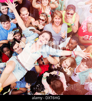 Femme enthousiaste crowd surfing at music festival Banque D'Images