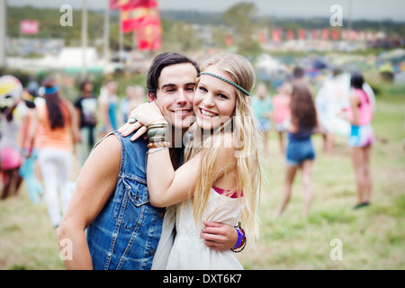 Portrait de couple hugging at music festival Banque D'Images