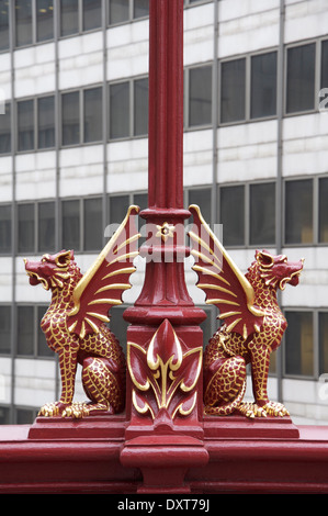 Gryphons fleuri rouge, avec des détails extraits de feuilles d'or, ornent les lampadaires de style Victorien sur l'Holborn Viaduct dans la ville de Londres. Angleterre, Royaume-Uni. Banque D'Images