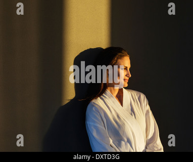 Pensive woman in bathrobe Banque D'Images