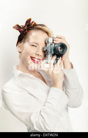 Jeune femme à l'aide de Photo Camera, Portrait Banque D'Images