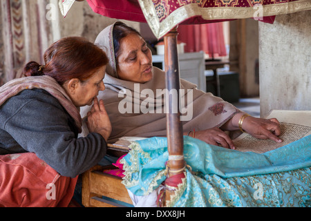 L'Inde, Dehradun. Femme lisant à partir de la Sainte Écriture pour les fidèles à un Sikh Temple construit en 1707. Banque D'Images