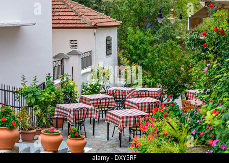 Tables de restaurant sur la terrasse donnant sur la rue avec beau fleurs autour de Banque D'Images