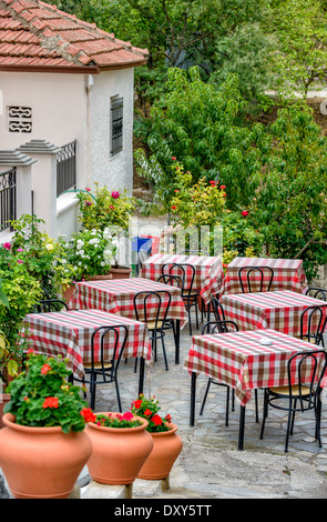 Tables de restaurant sur la terrasse donnant sur la rue avec beau fleurs autour de Banque D'Images