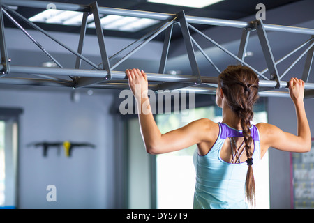 Young woman doing chin ups Banque D'Images