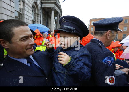 Dublin, Irlande. 7 avril 2014. Peu d'Owen (3) se trouve sur le bras de son père, portant son fire fighter's cap. Les pompiers de la Brigade des Pompiers de Dublin (DFB) ont protesté devant l'Hôtel de ville de Dublin pour le maintien de l'ambulance. Les propositions présentées par le conseil municipal de Dublin voir un examen et un éventuel déménagement du service à l'HSE (Health Service Executive) National Service d'ambulance. Crédit : Michael Debets/Alamy Live News Banque D'Images