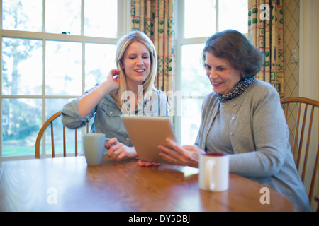 Senior woman and granddaughter looking at digital tablet Banque D'Images